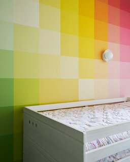 After: The rear room on the third floor got a treatment similar to the offices on the top floor; it was split down the middle to give each child their own room, which they had a hand in designing. Piper's rainbow-themed room features Colour Tones wallpaper from Rebel Walls.