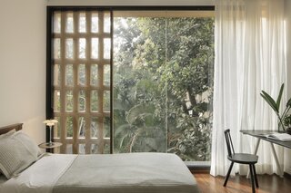 As is typical in Bangalore, the windows incorporate concrete <i>jalis</i>, lattice-like concrete screens that allow light and air to pass through while also serving a privacy function.