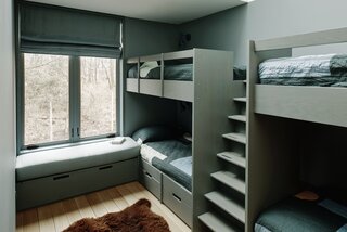 Custom bunk beds in the kids’ room were designed by ALAO and fabricated by Amber Construction &amp; Design. The quilts are from Cold Picnic and the stool is by Alvar Aalto for Artek.
