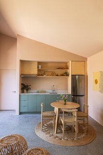 Danny fitted the kitchen into an alcove outfitted with Ikea cabinets and Semihandmade fronts. The refrigerator is by LG. On the jute rug from Armadillo, chairs from Threshold join a table from Inside Weather.