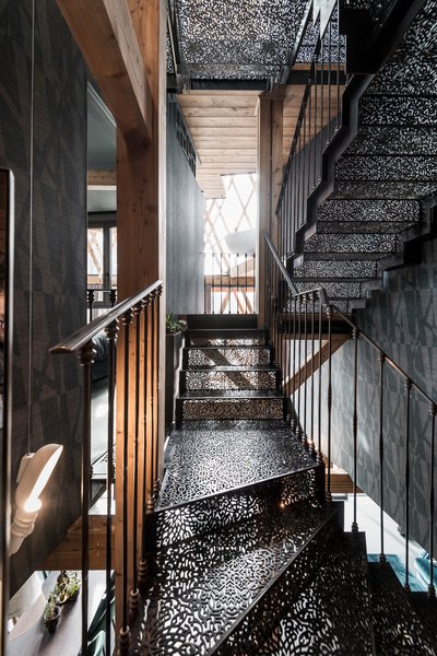 Found in Seis am Schlern, Italy, this ornate, gothic-style staircase is a showstopper. The black metal tread and railing heighten the home’s drama and elegance. Designed by Italy’s Network of Architecture, the idea behind the detailed staircase design is that the further one ascends, the more it heightens intimacy.