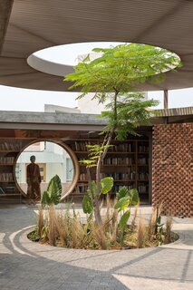 Located on the outskirts of Morelia, Mexico, the 5,920-square-foot UC House by architectural designer Daniela Bucio Sistos is grounded by a foyer with a raised, circular ceiling, which houses a tree that grows out from a hole in the floor at the center.