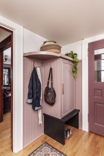 The renovation of a Victorian-era home in Portland, Oregon, included updating the entry area with new storage and a muted pink hue, picked in collaboration with the client. "She wasn't afraid of color," says Stephanie Dyer of Dyer Studio, who paired it with a deeper burgundy shade for the doors.