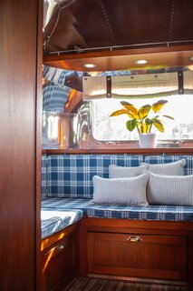 At the back of the Airstream, a U-shaped lounging area converts into a queen-sized bed for adults.