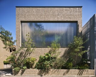 Hiroshi Nakamura & NAP used 87 translucent bricks to reframe a family’s connection to nature and the city.
