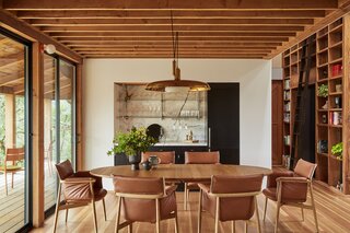 In the dining area, a Guild chandelier hangs above a table and chairs from Carl Hansen.