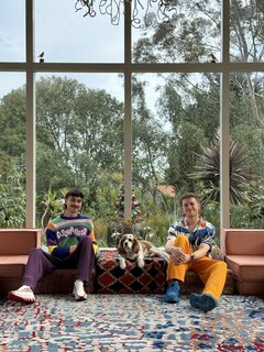 Josh Jessup (left), Louis the dog and Matt Moss, pictured in their rental home's "conversation pit."