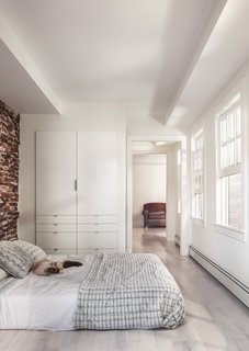 The renovation revealed a 30-foot-deep well beneath the bedroom, which the team half-jokingly considered turning into a fish tank. Instead, they opted for a simple bedroom with plenty of built-in storage.