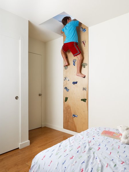 To access a secret play area in the 2 Bar House by Feldman Architecture, children clamber up climbing holds purchased from a local sporting goods store.