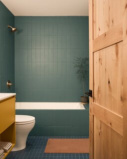 The all-over green tiles of this bathroom feel the most like camp.