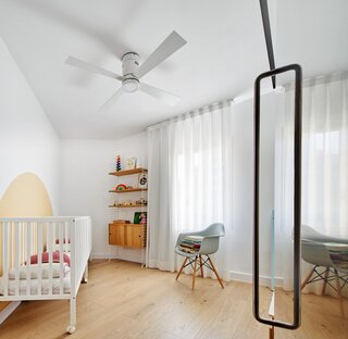 The nursery is situated in the chamfered corner of the 1950s apartment house.