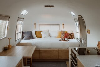 The open bed area is nestled into the front of the Airstream, resting upon dresser-drawers that stretch into the wheel wells.