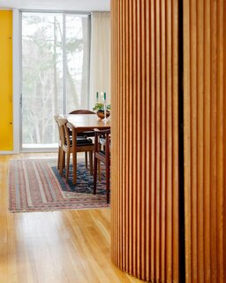 The original curved wall that extends from the playroom to the dining area opens to reveal a hidden closet. 